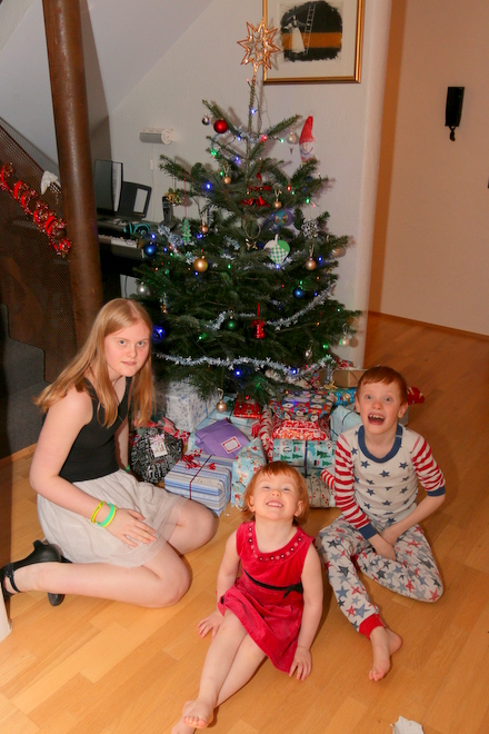 Kids in front of the all-important pile of presents!