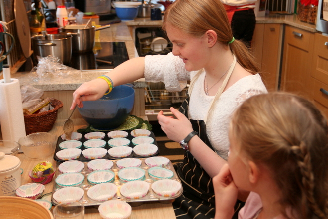 Anna making muffins for her birthday celebration later on.